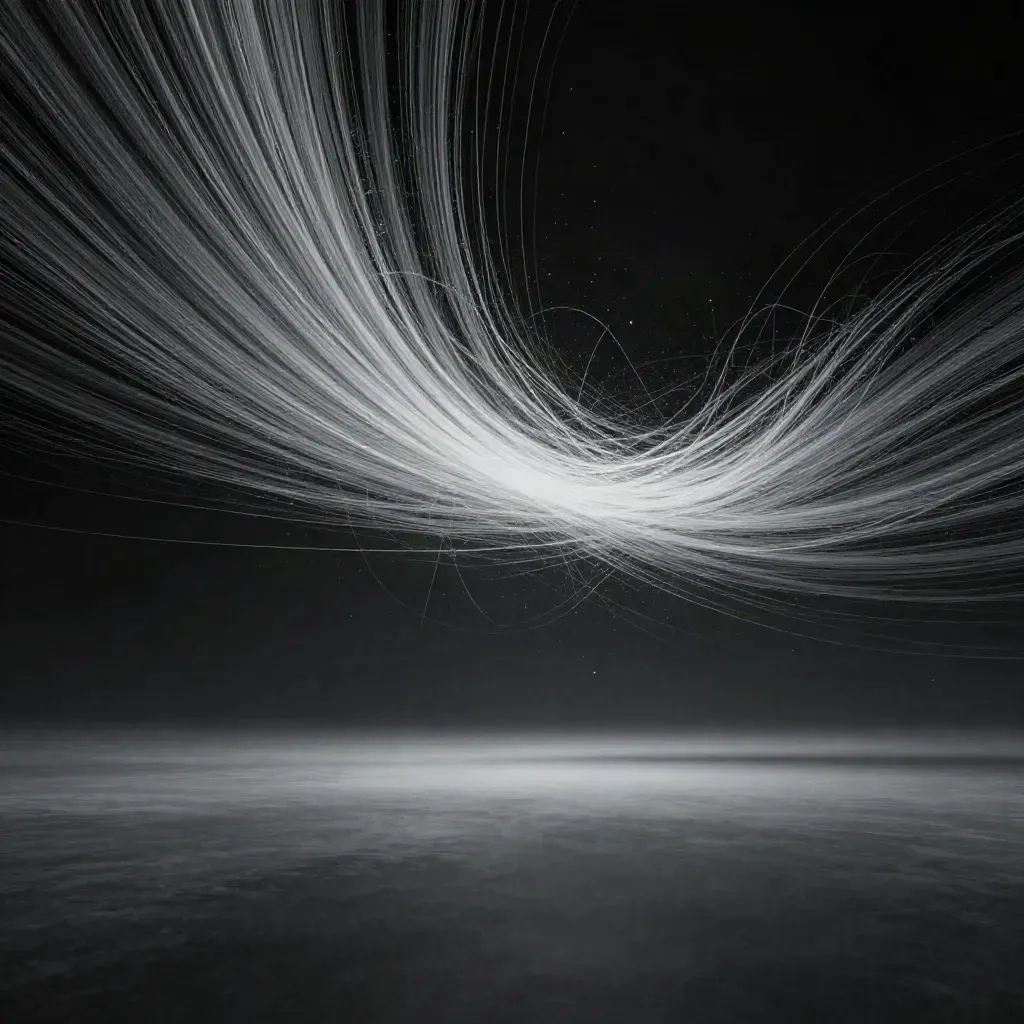 Silver particle streams converging into a soft white bloom on graphite space